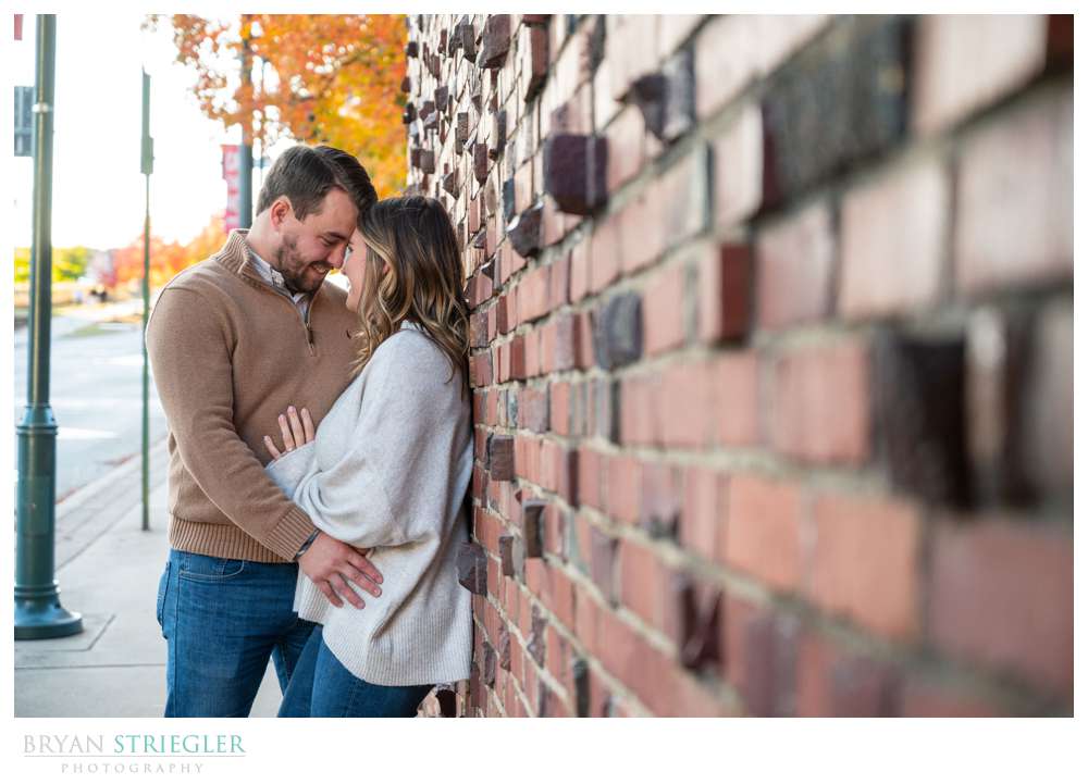 leaning against brick wall